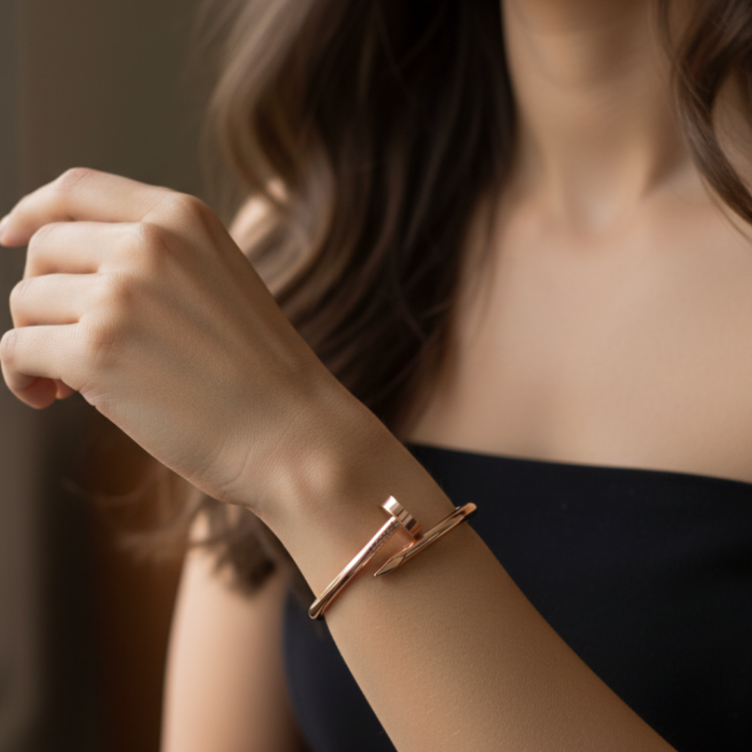 Woman wearing a rose gold bracelet in front of a window