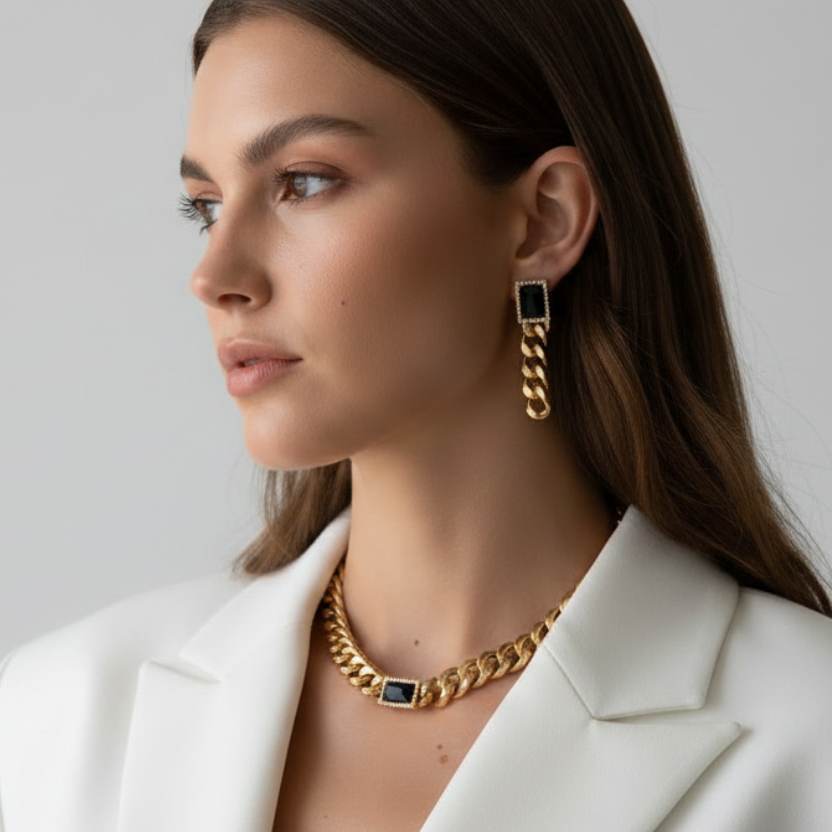 Woman wearing gold jewelry against a plain background